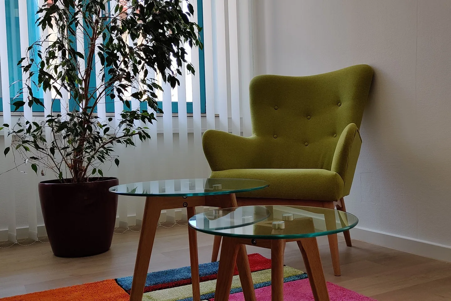 Waiting area with a green armchair in our Budapest office